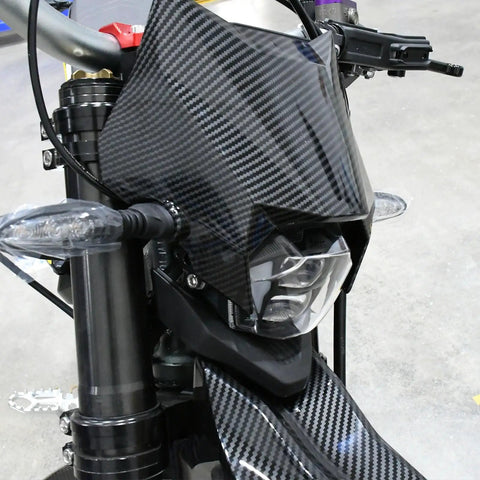 Ultra Bee Headlight Cover With Dope Carbon Fiber Look Fender Mud Guard For Electric Dirt Bike, close-up view on bike