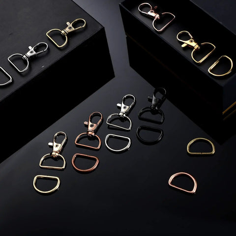 100 Piece Hardcore Swivel Keychain Clips With D Rings And Lobster Clasps, assorted colors and styles on black background.