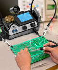 Pro Grade 130W Digital Soldering Station Kit With 5 Extra Tips in use on PCB, showing lead-free solder and helping hands.