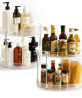 Two Pack Two Tier Clear Acrylic Lazy Susan Turntable Organizer with cosmetics and condiments on a smooth rotating tray.