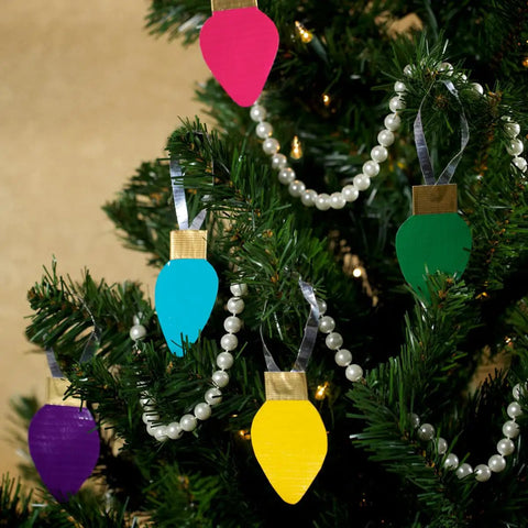 Colorful DIY Christmas ornaments made with Heavy Duty White Duct Tape 3 Pack 1.88 Inch By 30 Yard Rolls hanging on a tree