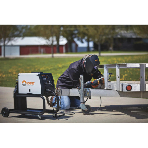 Welder using Compact Running Gear and Cylinder Rack in Black With Under Machine Cable Tray Assembly Required Fits Gas Cylinders Up To 7 Inches Ideal for Welders and Shop Setups outdoors