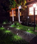 Bronze Solar Path Light Set Of 6 With Glass Lens and super bright LED illuminating a garden walkway at night.