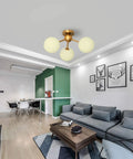 3 Light Modern Globe Ceiling Light Mid Century Sputnik Chandelier With White Glass Shades Brushed Brass Finish Semi Flush Mount in living room