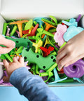 Children's hands assembling Flower Garden Building Toy With Insect Pegs 153 Piece STEM Stacking Pretend Play Set parts