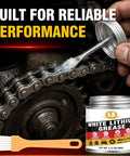 Applying heavy duty lithium grease with built-in brush to chain, reduces wear and friction, ideal for home and industrial use.