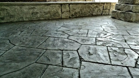 Heavy Hitter Concrete Curing Agent And Sealer With Low VOC Formula In 5 Gallon Size applied on decorative textured concrete floor.