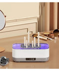 Portable Ultrasonic Cleaner With Rechargeable Battery For Jewelry And Watches on a table with tools and a watch nearby.