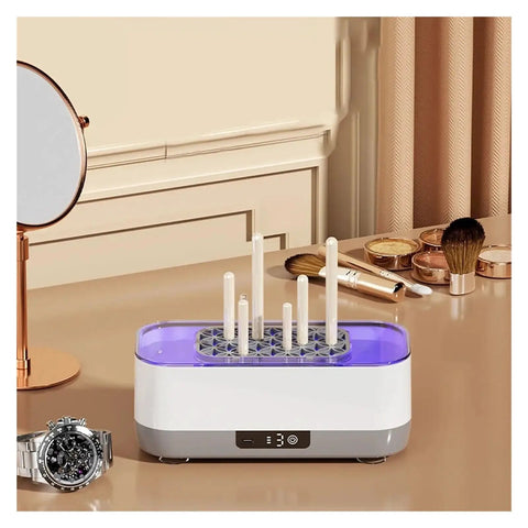 Portable Ultrasonic Cleaner With Rechargeable Battery For Jewelry And Watches on a table with tools and a watch nearby.