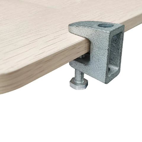 Three Eighths Inch Metal Beam C Clamp for wall ceiling flange mounts attached to wooden surface, showing galvanized finish.