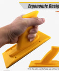 Person holding yellow push block with ergonomic handle, part of Two Pack Safety Push Blocks For Woodworking With Ergonomic Rounded And Angled Handles Pro Grade Grip For Router Table And Planer Heavy Duty ABS Plastic For Easy Control And Safer Faster Work.