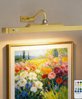 Premium Rechargeable Motion Sensor Picture Light Gold Wall Mounted Frame Illuminator above vibrant floral art.