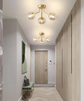 Three Light Sputnik Chandelier In Bold Gold Finish Semi Flush Mount Ceiling Light Fixture With Glass Globe in hallway