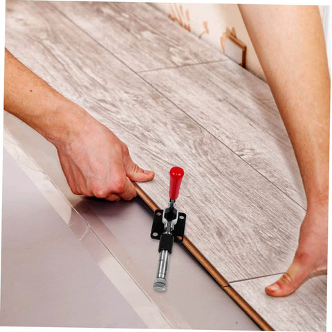 Fast Locking Level Fastener Push Pull Clamp For Vertical Fixtures in use on wood paneling, red handle, metal toggle catch.
