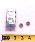 Two Pack New H1200 HXCU 0606 HPR IC830 AlTiN And TiN Coated Carbide Inserts next to tape measure for size reference