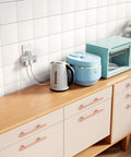 Rose Gold Cabinet Handles And Knobs Set Of 10 for drawers and dressers with 4 inch hole centers and stainless steel finish, installed in modern kitchen.