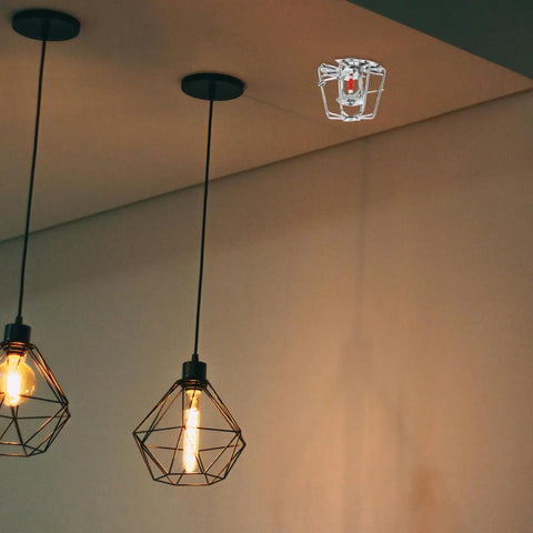 Robust Fire Sprinkler Guard 2 75 Inch Universal Head Cover KnockOut Bump Shield Easy Grip No Sweat Snap Install For Flush Side Wall Setup Home Office Vibe mounted above stylish hanging lights.