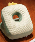 Green Cool Ice Silk Napping Face Pillow For Table Naps with ergonomic design on a wooden surface