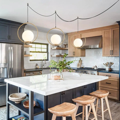 Plug In Globe Pendant Light Fixture With White Glass Ball And Brushed Brass Ring in modern kitchen setting