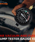 Fuel Pump And Vacuum Tester Gauge For Car Carburetor Diagnostics With Leak Testing Lets You Nail Fuel Pump Pressure To 10 PSI And Read Engine Vacuum To 28 InHg Includes Large Three And A Half Inch Adapters And Red Blow Mold Case. hand holding black 3.5-inch fuel and vacuum tester gauge