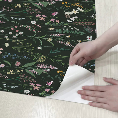 Person peeling Farm Floral Peel And Stick Wallpaper For Walls And Cabinets Dark Wildwood Look Self Adhesive Contact Paper