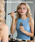 Woman using Portable Handheld Fan With Semiconducting Cooling For Quick Face And Neck Chill during makeup routine