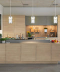 Modern Cylindrical Pendant Light With Dual Shade In Brushed Nickel And Clear Glass For Kitchen Island Sink Dining Room Bar And Foyer Sleek Industrial Style Lighting For Modern Kitchens And Dining Areas installed over kitchen island.