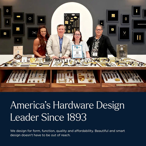 Display of hardware designs with four people standing behind a counter showcasing various cabinet knobs and handles.