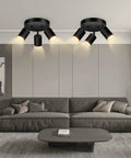 Three Light Matte Black Track Lighting Kit With Adjustable GU10 Heads installed in living room above couch.