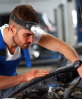 Man working on car engine wearing Rechargeable LED Headlamp With Motion Sensor, 1000 Lumen Beast Mode Bright Light