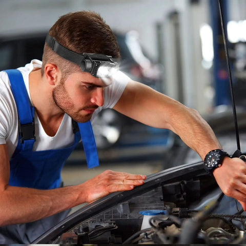 Man working on car engine wearing Rechargeable LED Headlamp With Motion Sensor, 1000 Lumen Beast Mode Bright Light