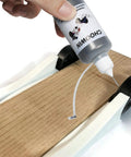 Applying Pro Grade Graphite Powder Lubricant For Pinewood Derby Cars And Locks, Door Hinges, Wheels And Axles from 60 ml bottle onto axles