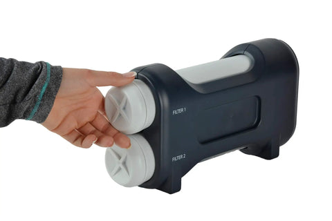 Hand replacing filter in under sink water filtration system with chrome faucet, 2-stage UltraEase filters, space saving cabinet design