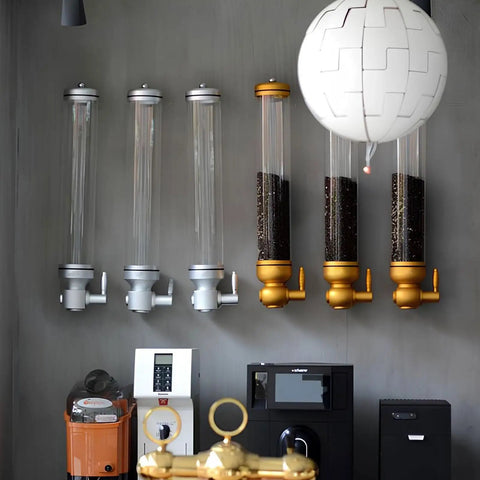 Killer Wall Mounted Coffee Bean Dispenser With Durable Aluminum And Clear Acrylic Canister Totally Airtight 5KG Storage Jar For Home Baristas Or Cafe Stash In Glossy Gold Two Pack mounted on a wall with coffee beans inside.