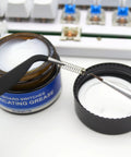 Aluminum Switch Opener And Lube Kit For Custom Keyboards With Tweezers And Four Claw Gripper shown with lubricating grease jar