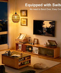 Homebody Essential Plug In Pendant Light Featuring Hand Woven Rattan And Wicker Egg Shade With 15 Ft Cord illuminating cozy living room.