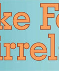 I Brake For Squirrels magnet: orange text on teal background with cartoon squirrel, 10x3 inches