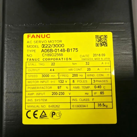Label on AC servo motor showing specifications including model α22/3000 by FANUC with speed 3000 RPM and 132V input.