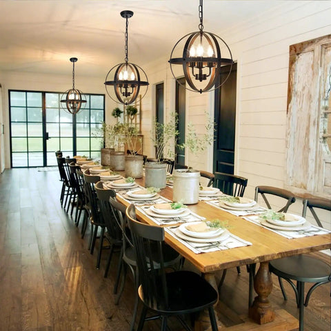 Three Light Vintage Pendant Chandelier In Matte Black With Spherical Shades in dining room setting