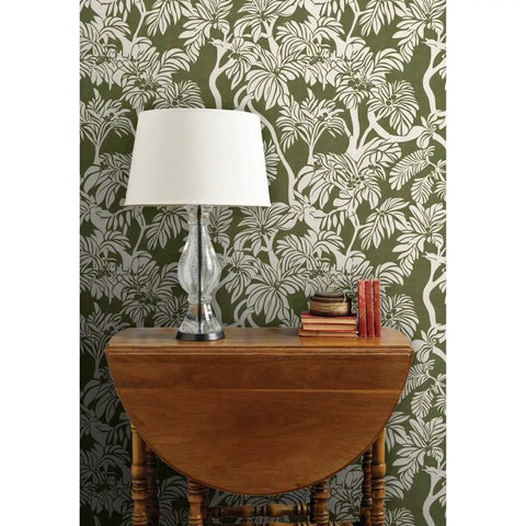 Top Notch Type II Professional Tropical Jungle Wallpaper Featuring Hella Durable Matte Finish and Subtle Linen Texture against a green background with a lamp and side table.