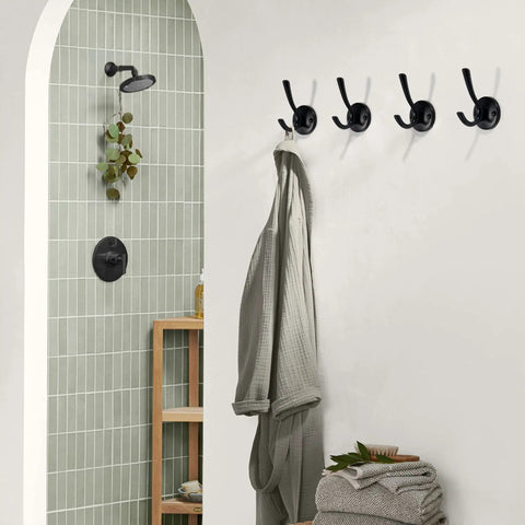 Bathroom scene with 5 Pack Round Coat And Towel Hooks Matte Black Wall Mounted Zinc Alloy Heavy Duty Hangers holding a robe