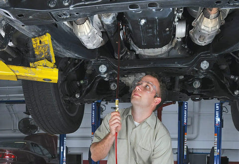 Mechanic using All-In-One ATF Refill Kit For MV7201 Fluid Extractor With Brass Ball Valve And Quick-Change Coupler under vehicle