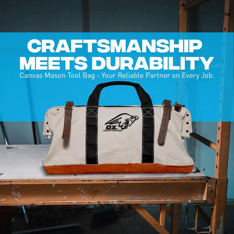 Heavy Duty Canvas Tool Bag 24 Inch Wide With Reinforced Frame And Suede Leather Bottom on a workbench, front view