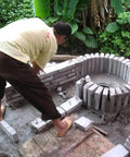Person constructing circular brick base for 15KW Hydroelectric Generator For Home Backup 400V Three Phase Axial Flow Outdoor System
