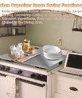 Stainless Steel Stove Top Cover Noodle Board Kitchen Organizer For Gas And Electric Stoves Expands Counter Space And Doubles As A Cutting Board Sink Cover 30 By 22 By 3 Inches Silver on a stove with dishes and condiments.