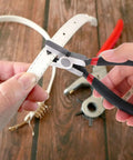 Using 2.0mm Shoe Strap Hole Puncher for Watch Bands Leather Belts on white strap, one hand operation pliers tool for DIY repairs.