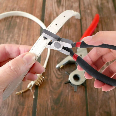 Using 2.0mm Shoe Strap Hole Puncher for Watch Bands Leather Belts on white strap, one hand operation pliers tool for DIY repairs.