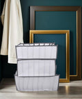 Total Closet Game Changer 3 Pack Seven Grid Foldable Bins With Grippy Handles, stacked white storage boxes for clothing organization.