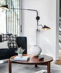 Retro Dope Plug In Wall Sconce With Swivel Arm And Adjustable Head in living room next to sofa, industrial black metal light.
