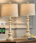 Set Of 2 27.75 Inch 3 Way Dimmable Touch Table Lamps With USB Ports Bulb Included Linen Washed Finish Rustic Farmhouse Nightstand Lighting For Living Room And Bedroom displayed on a table with a hand reaching to a book.